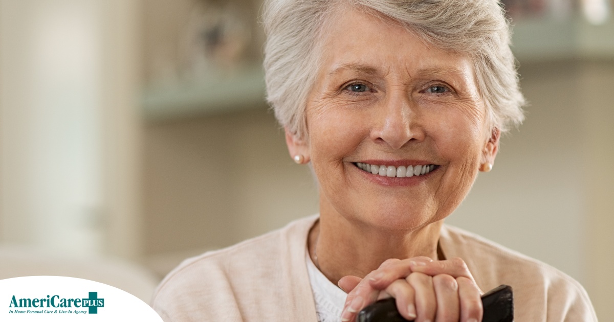 An older woman with healthy teeth smiles, representing good dental hygiene.